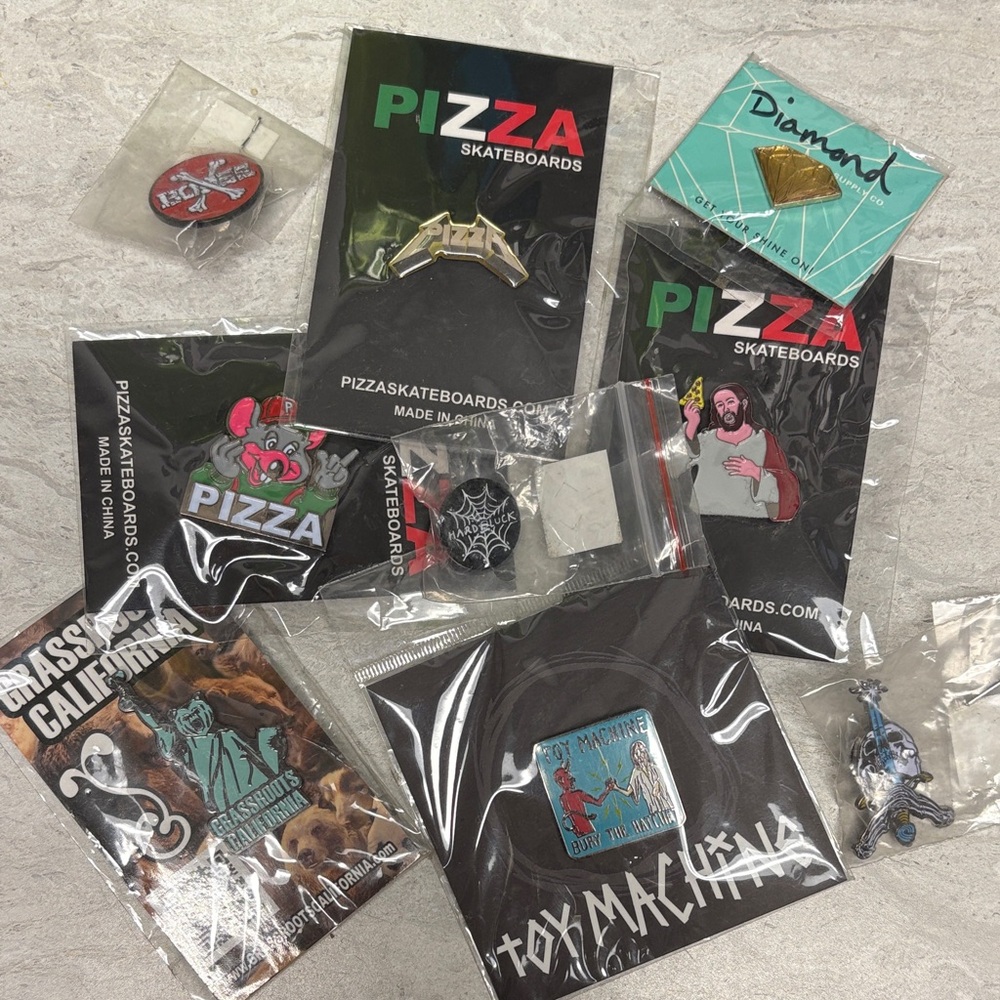 Assorted 9 enamel skateboard pins.